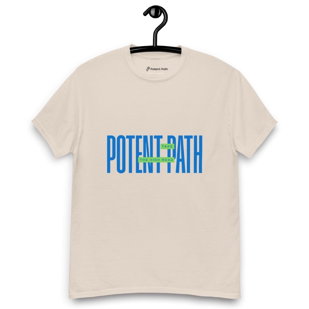 Beige t-shirt on a hanger featuring large blue text that reads "POTENT PATH," with a small green overlay in the centre containing the words "TAKE THE HIGH ROAD"