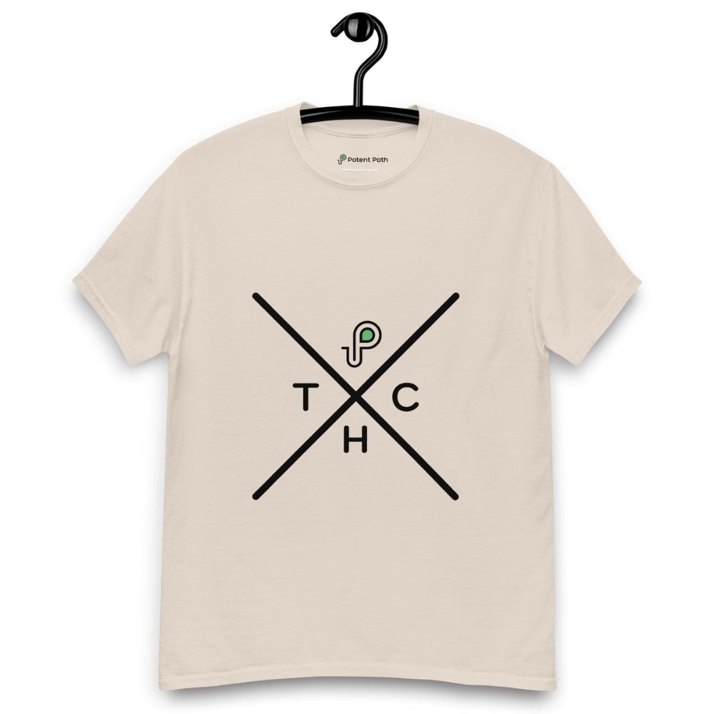 Beige t-shirt on a hanger featuring a minimalist crossed-line design with the letters T, H, C, arranged in the quadrants, and a small green-and-black "P" logo positioned above the centre of the cross