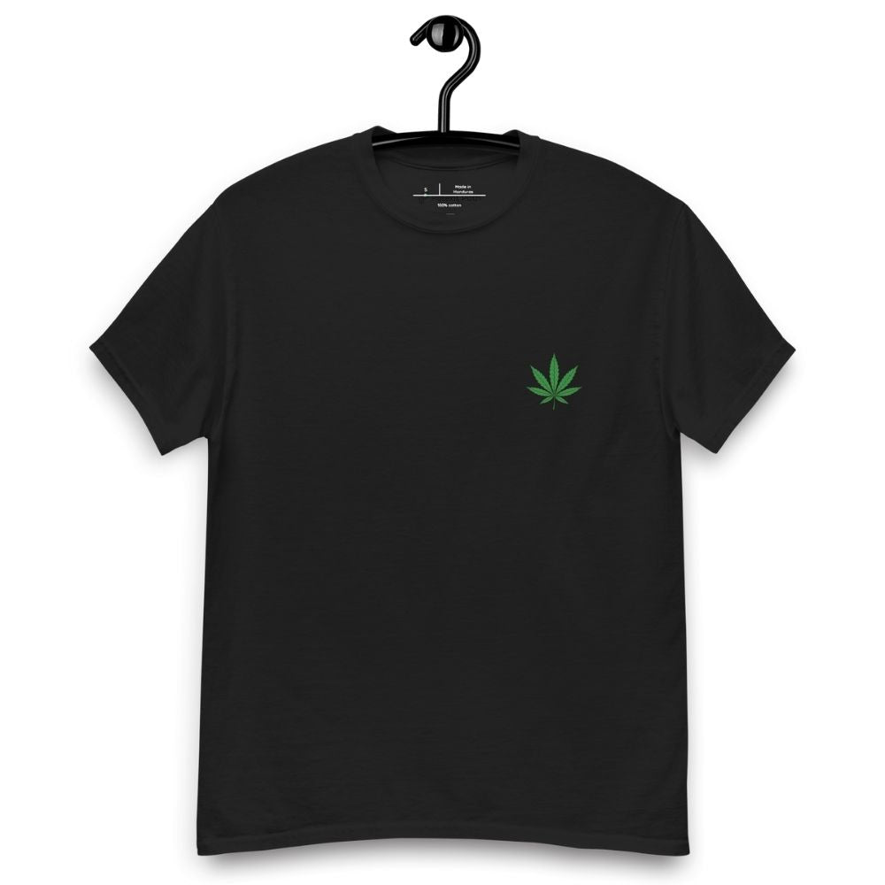 Black t-shirt with a green leaf design on a hanger against a white background