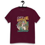 Burgundy T-shirt on a hanger featuring a colourful illustration of a woman with long blonde hair, round pink sunglasses, and a flower in her hair, smoking weed with swirling smoke around her and text "Gypsy Hippie Girl" above and "Smoke Weed" below