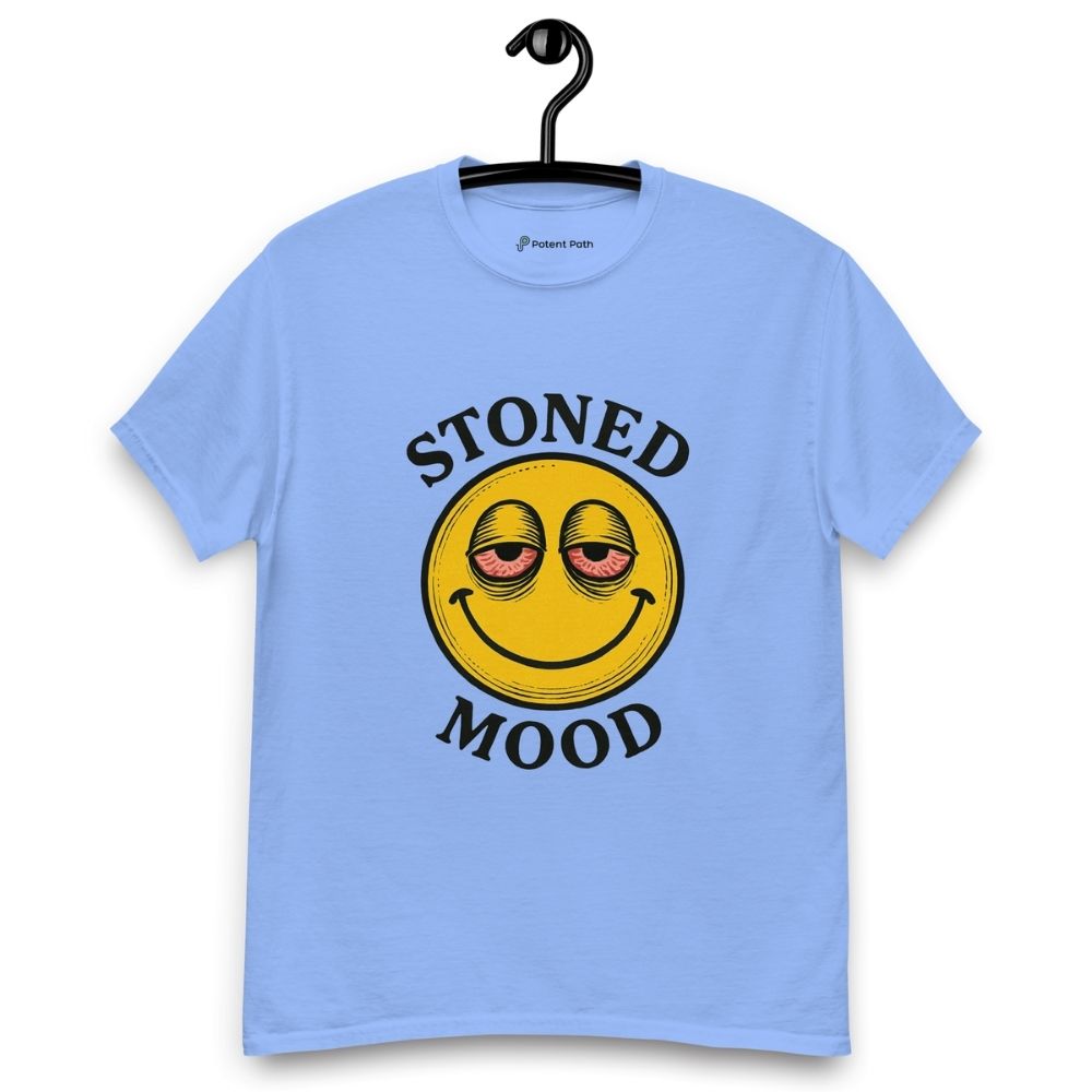 Carolina blue colour T-shirt on a hanger with a yellow smiley face with droopy, bloodshot eyes and the phrase "STONED MOOD" printed above and below the graphic