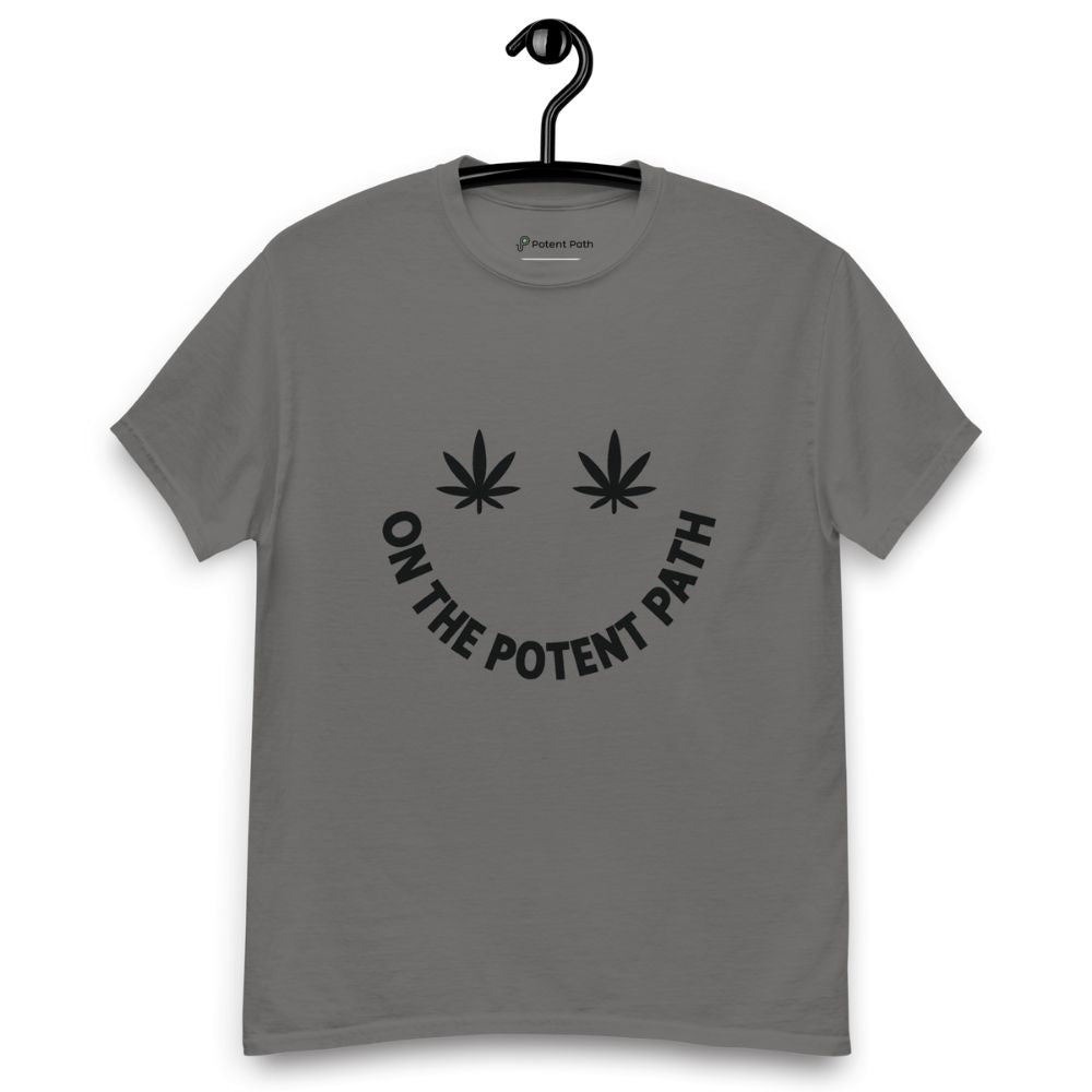Charcoal grey t-shirt on a hanger featuring curved text reading "ON THE POTENT PATH" in the form of a smiley face and two black cannabis leaves above to represent the eyes