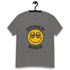 Grey T-shirt on a hanger with a yellow smiley face with droopy, bloodshot eyes and the phrase "STONED MOOD" printed above and below the graphic