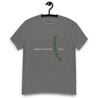 Charcoal grey t-shirt on a hanger featuring the phrase "Walking The Potent Path Slowly" in white text across the chest, with a vertical trail of small green footprints with cannabis leaves inside between "Path" and "Slowly"