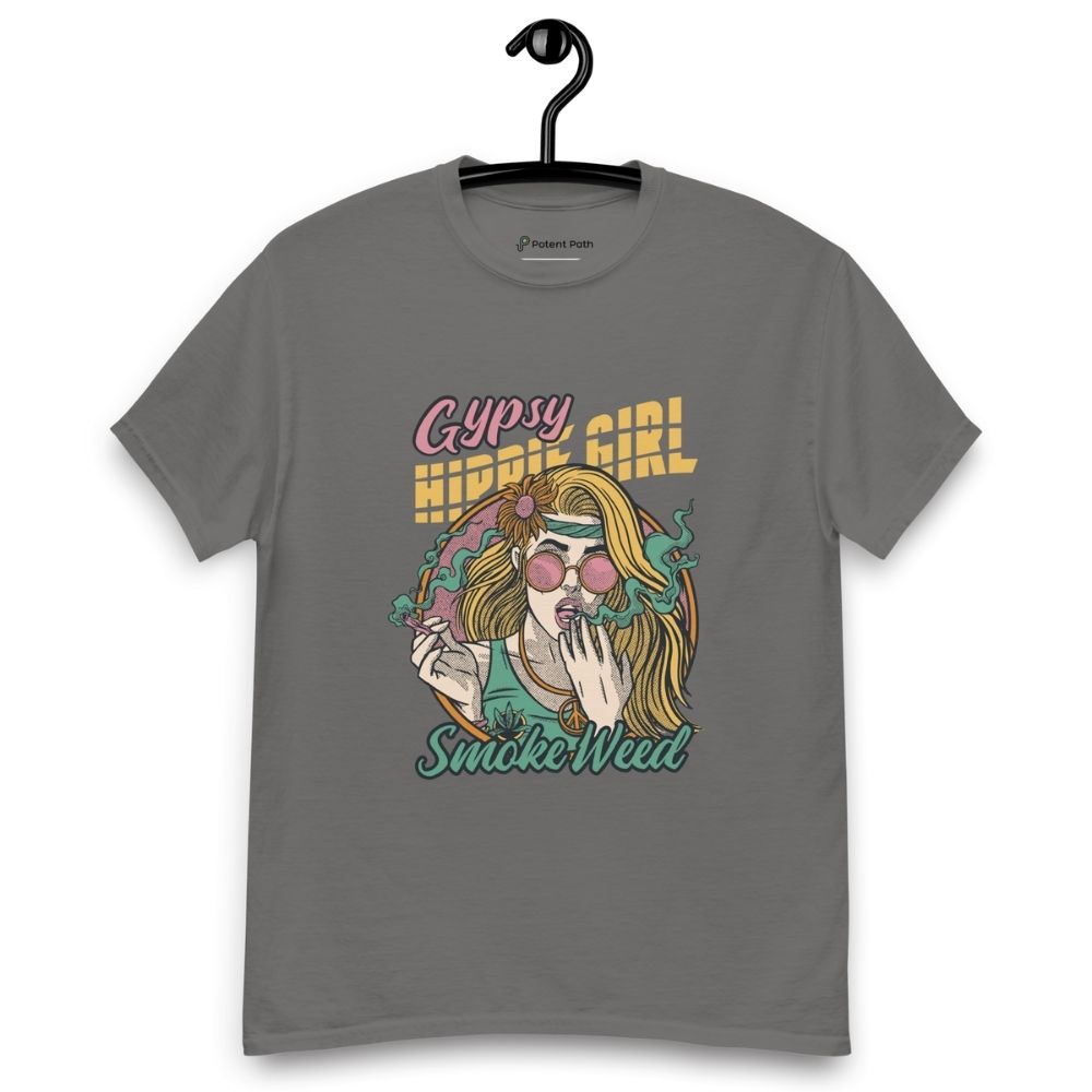 Charcoal colour T-shirt on a hanger featuring a colourful illustration of a woman with long blonde hair, round pink sunglasses, and a flower in her hair, smoking weed with swirling smoke around her and text "Gypsy Hippie Girl" above and "Smoke Weed" below