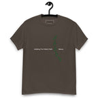 Dark chocolate colour t-shirt on a hanger featuring the phrase "Walking The Potent Path Slowly" in white text across the chest, with a vertical trail of small green footprints with cannabis leaves inside between "Path" and "Slowly"