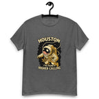 Dark grey t-shirt on a hanger featuring a cartoon astronaut holding a cannabis leaf, surrounded by stars, with the text "HOUSTON I'VE FOUND A HIGHER CALLING”