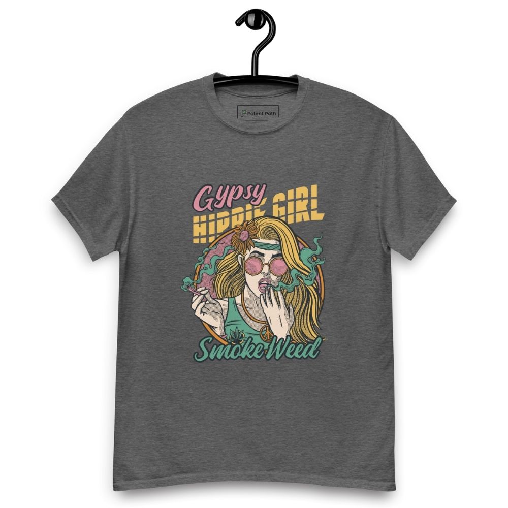 Dark heather T-shirt on a hanger featuring a colourful illustration of a woman with long blonde hair, round pink sunglasses, and a flower in her hair, smoking weed with swirling smoke around her and text "Gypsy Hippie Girl" above and "Smoke Weed" below