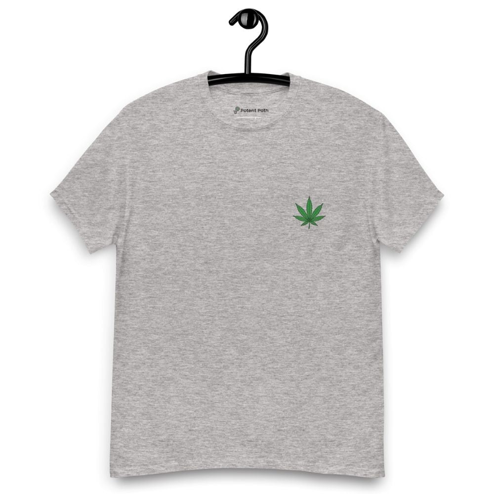 Grey t-shirt with a green cannabis leaf logo on a hanger against a white background