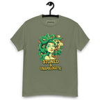 Military green T-shirt on a hanger featuring a Medusa head smoking a joint with green snake hair, and the text "STONED & UNAPOLOGETIC" below