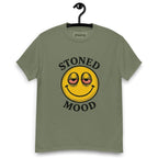 Green T-shirt on a hanger with a yellow smiley face with droopy, bloodshot eyes and the phrase "STONED MOOD" printed above and below the graphic