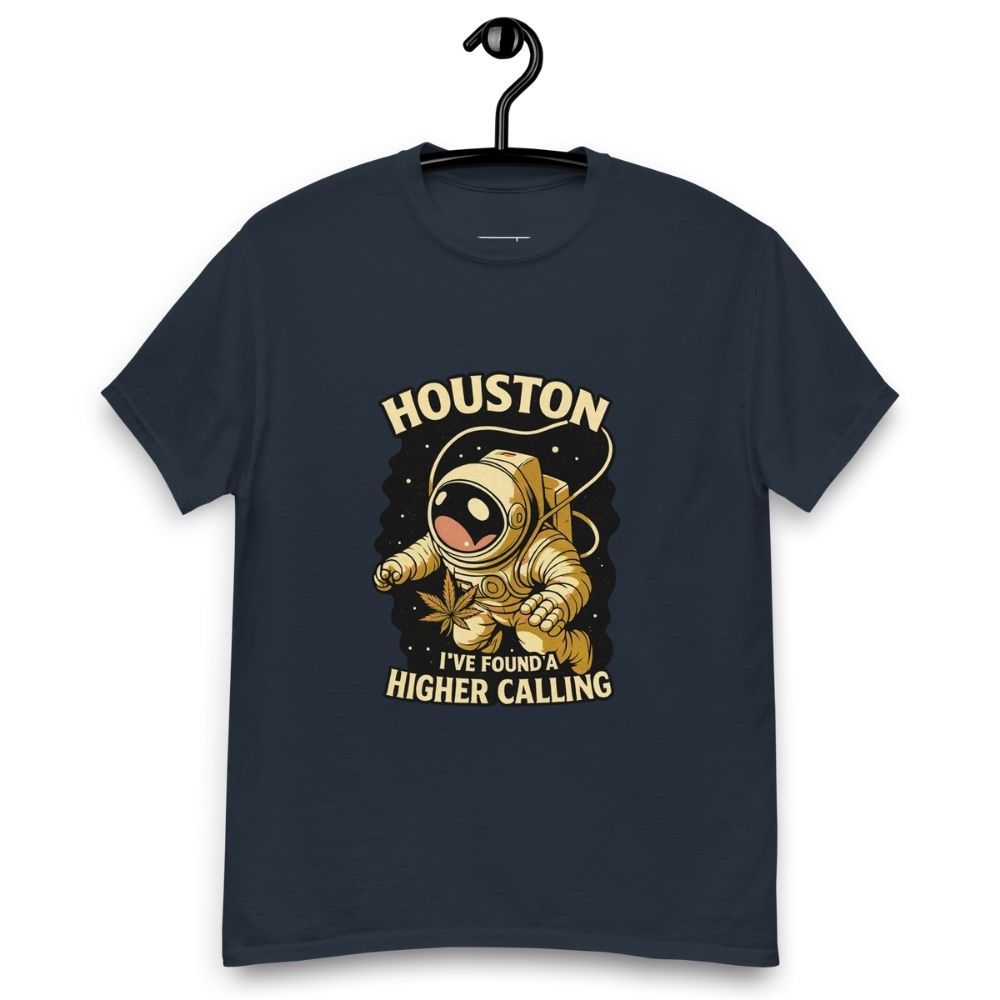 Navy blue t-shirt on a hanger featuring a cartoon astronaut holding a cannabis leaf, surrounded by stars, with the text "HOUSTON I'VE FOUND A HIGHER CALLING”