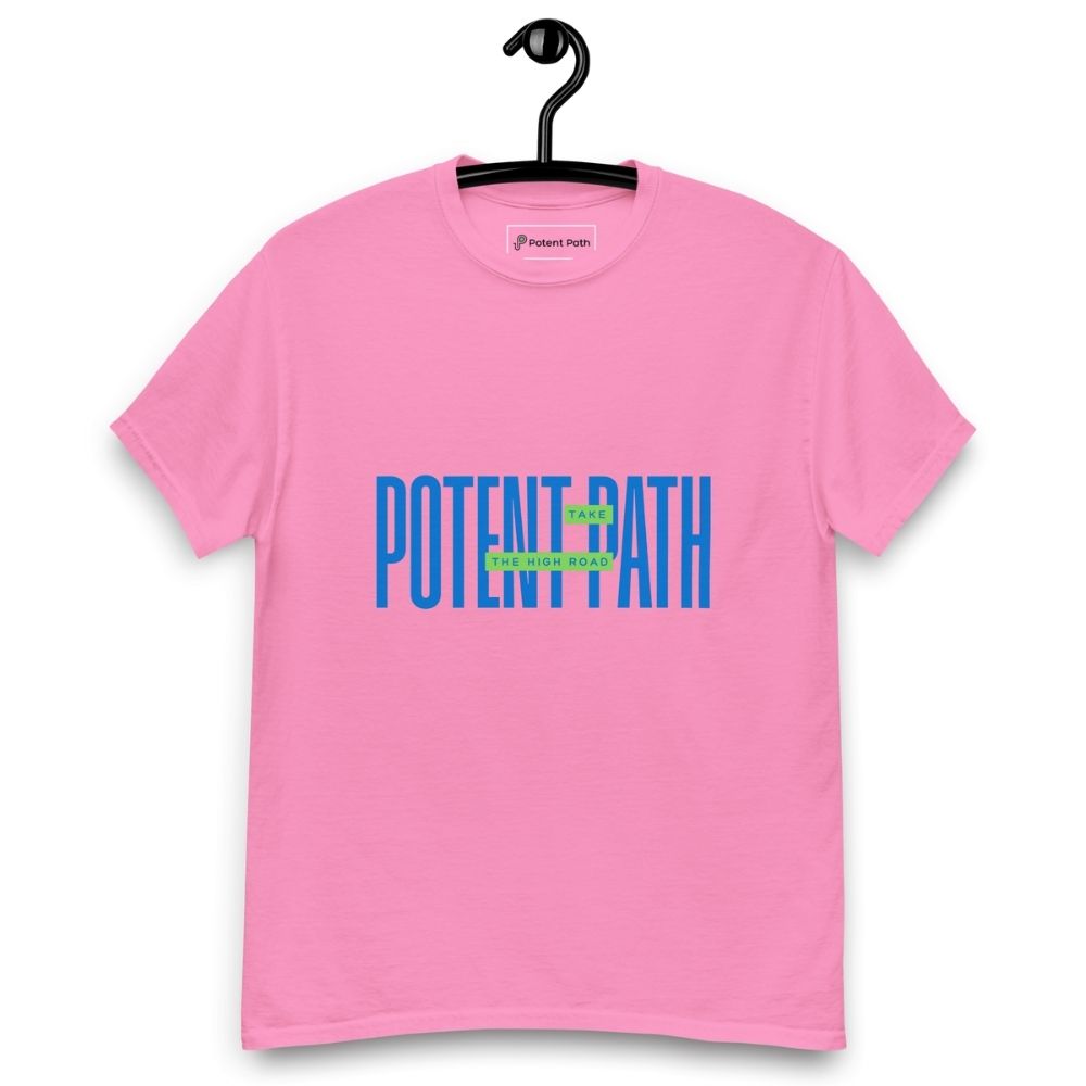 Pink t-shirt on a hanger featuring large blue text that reads "POTENT PATH," with a small green overlay in the centre containing the words "TAKE THE HIGH ROAD"