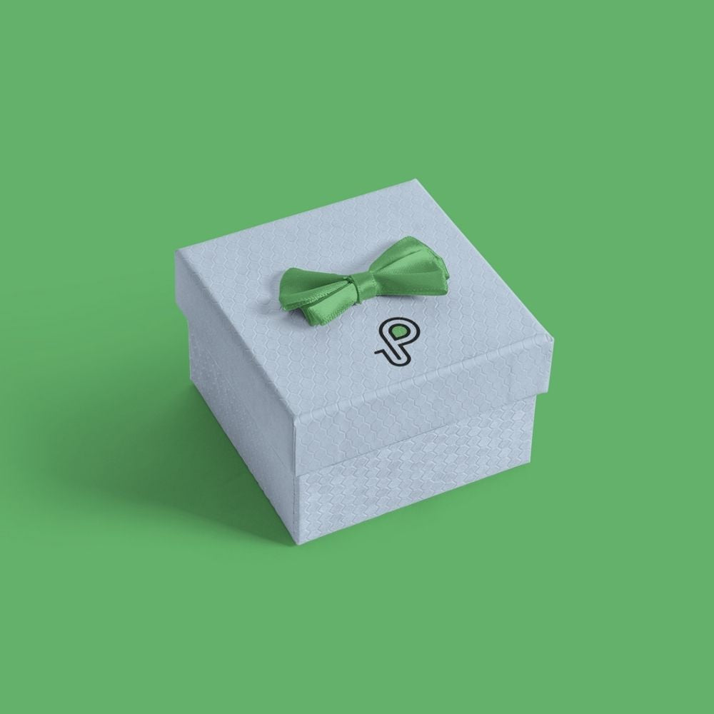 Small light blue gift box with a green bow and a P logo on its lid on a green background
