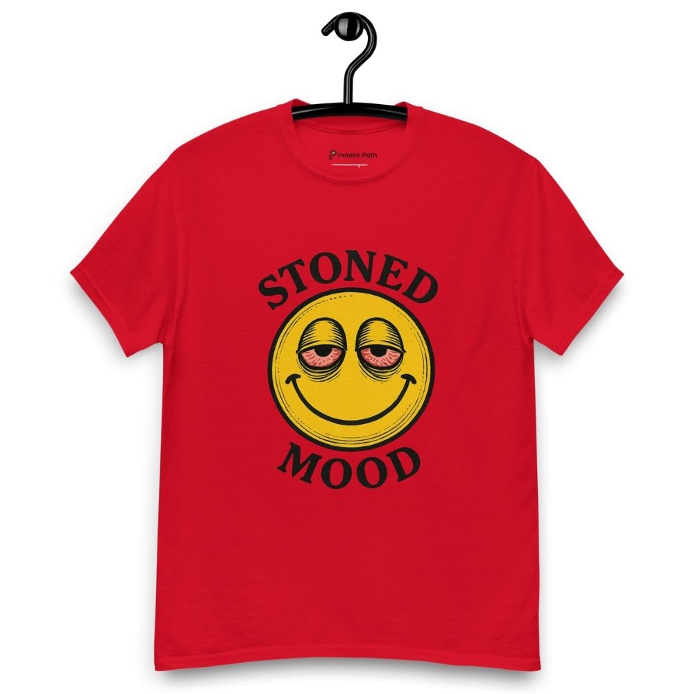 Red T-shirt on a hanger with a yellow smiley face with droopy, bloodshot eyes and the phrase "STONED MOOD" printed above and below the graphic