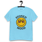 Light blue T-shirt on a hanger with a yellow smiley face with droopy, bloodshot eyes and the phrase "STONED MOOD" printed above and below the graphic
