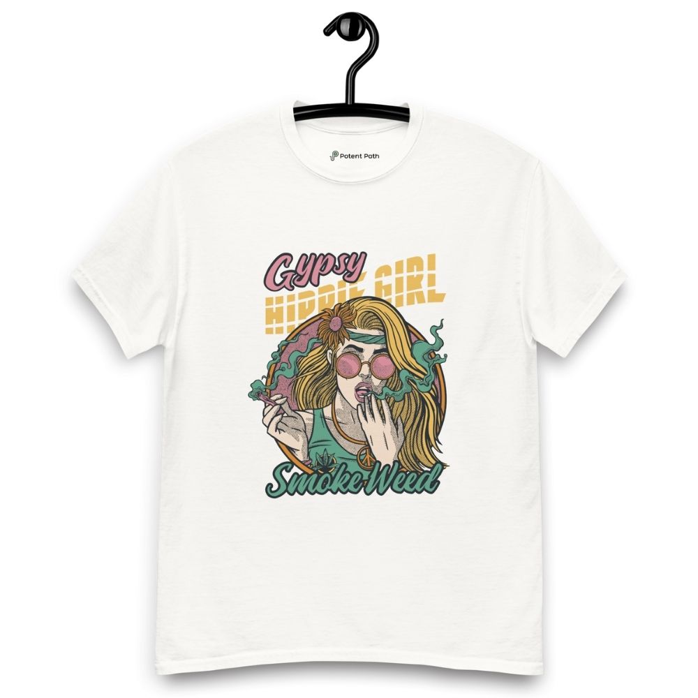 White T-shirt on a hanger featuring a colourful illustration of a woman with long blonde hair, round pink sunglasses, and a flower in her hair, smoking weed with swirling smoke around her and text "Gypsy Hippie Girl" above and "Smoke Weed" below