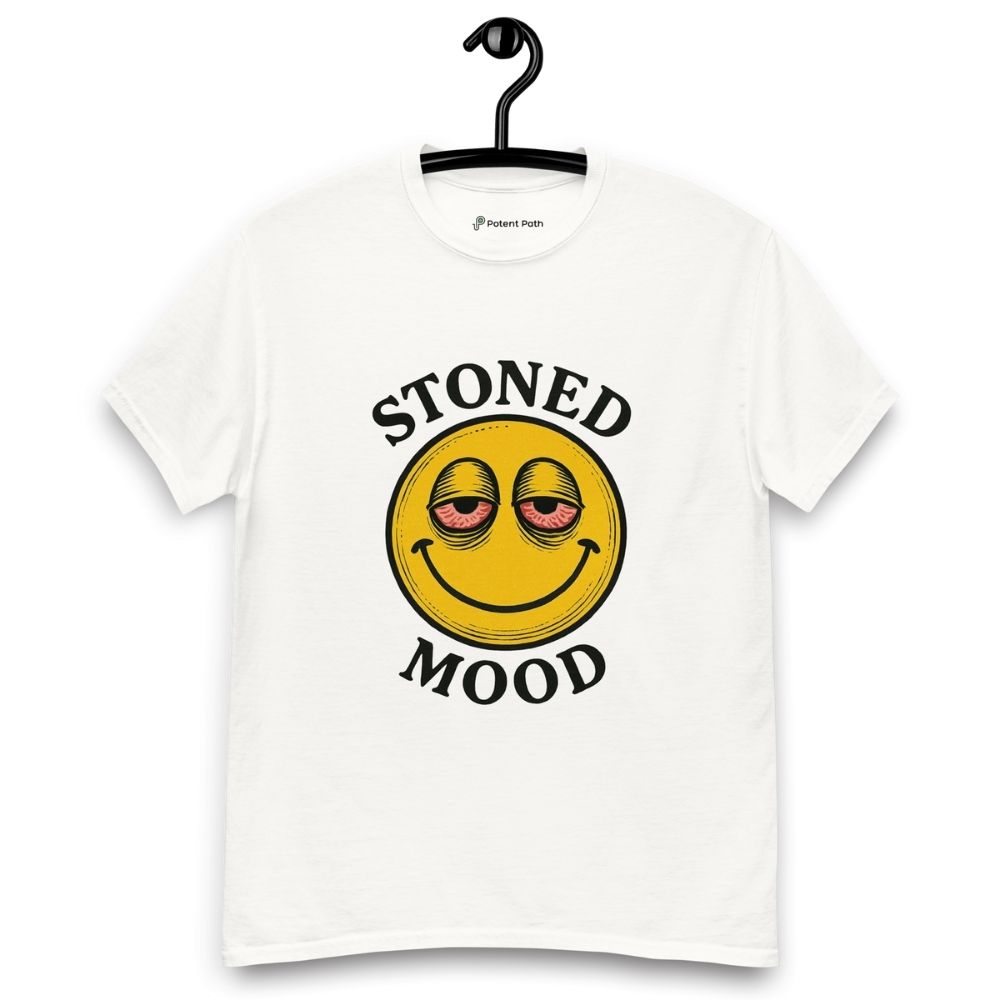 White T-shirt on a hanger with a yellow smiley face with droopy, bloodshot eyes and the phrase "STONED MOOD" printed above and below the graphic