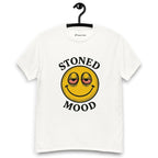 White T-shirt on a hanger with a yellow smiley face with droopy, bloodshot eyes and the phrase "STONED MOOD" printed above and below the graphic